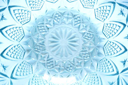 Texture of flower lattice pattern on crystal transparent utensils or crystal bowl, glass bowl, blue color, isolated on white background, close upの写真素材