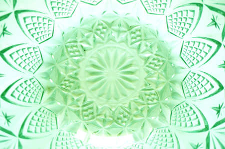 Texture of flower lattice pattern on crystal transparent utensils or crystal bowl, glass bowl, green color, isolated on white background, close upの写真素材