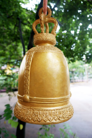 Traditional golden bell in temple of Thailand on natural background