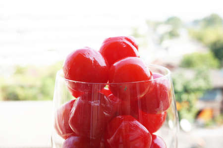Pickled Cherries  in champagne glass with natural backgroundの写真素材