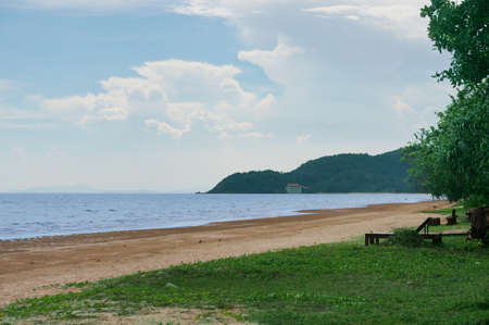 Blue sea and blue sky with mountain, tree, in natural beach backgroundの写真素材