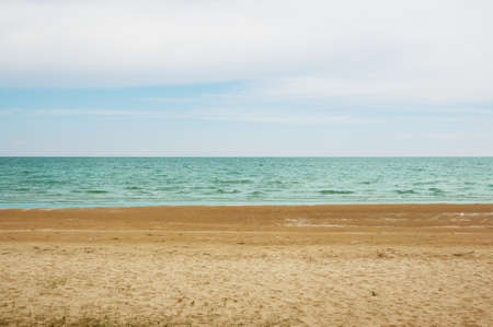 Emerald sea and the beach with blue sky backgroundの写真素材