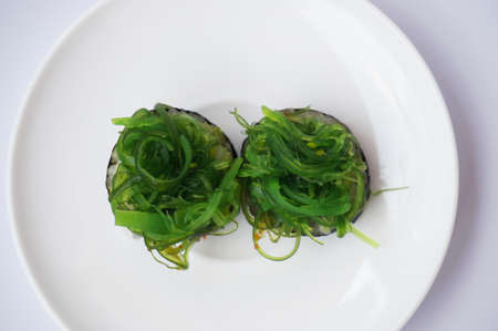 Asia - Asian eating food, Japanese food, seaweed sushis isolated on white background, close up.の写真素材