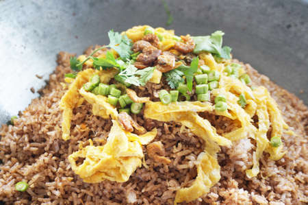 Asia - Asian eating food, Thai food, Fried rice mixed with shrimp paste  in a wok served with sweet pork, Thai omelet and vegetablesの写真素材