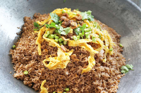 Asia - Asian eating food, Thai food, Fried rice mixed with shrimp paste  in a wok served with sweet pork, Thai omelet and vegetablesの写真素材