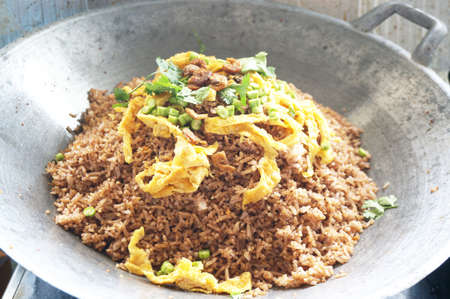 Asia - Asian eating food, Thai food, Fried rice mixed with shrimp paste  in a wok served with sweet pork, Thai omelet and vegetablesの写真素材