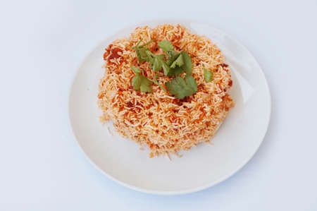 Asia - Asian eating food, Thai food, Mee Grob is an sweet and sour crispy noodles, made from Thai rice noodle with sweet and sour sauce decorated with coriander on white plate isolated on white background, close upの写真素材