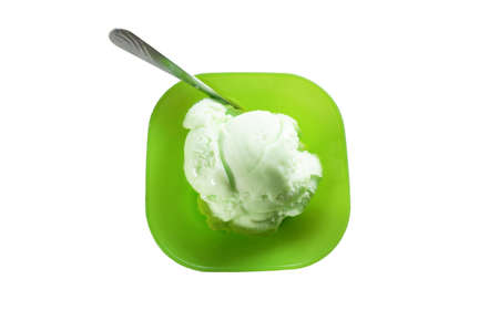 A photo of scoop of lime-vanilla ice cream on green bowl isolated on white background, close upの写真素材