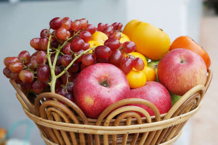 A photo of fresh mixed fruits for eat, grape, apple, orange, guava and persimmon close upの写真素材