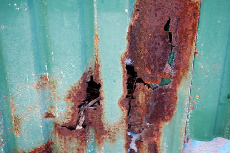 A photo of green Galvanize Sheet Abstract with a hole of rust texture and background, close upの写真素材
