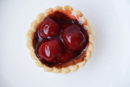 Fresh Homemade dessert mini Fruit Tart with red cherry isolate on white backgroundの写真素材