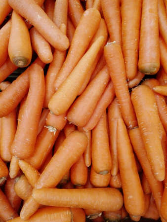 Close up of photo of very fresh orange carrots background in a stallの写真素材