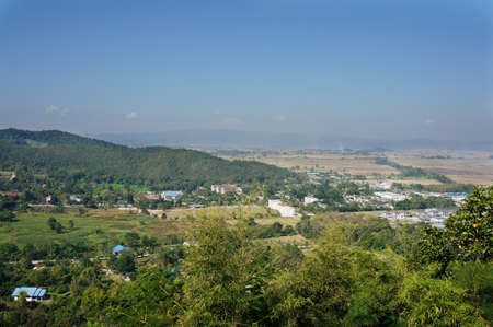 A photo of landscape of village in the valley and beautiful blue sky in a winter day at Chiang Rai province, northern of Thailandの写真素材