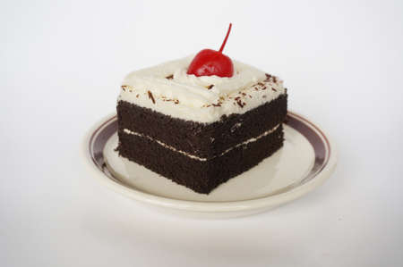 Colorful chocolate black forest cake decorated with cherry isolated on white background, close upの写真素材