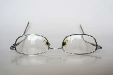 A photo of old reading glasses isolated on white background, close upの写真素材