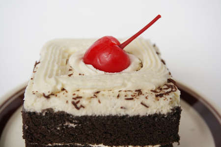 Colorful chocolate black forest cake decorated with cherry isolated on white background, close upの写真素材
