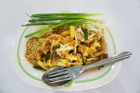 Asia-Asian food, Thai food, Pad Thai Goong Sod: Stir Fried Rice Noodle with Shrimp, lime and spring onion isolated on white background, close upの写真素材