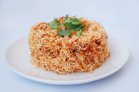 Asia - Asian eating food, Thai food, Mee Grob is an sweet and sour crispy noodles, made from Thai rice noodle with sweet and sour sauce decorated with coriander on white plate isolated on white background, close upの写真素材