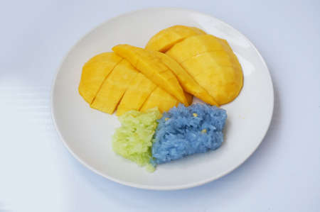 Asia - Asian eating food, Thai dessert, Sticky rice in coconut cream with sweet ripe mango  on white plate isolated on white background, close upの写真素材