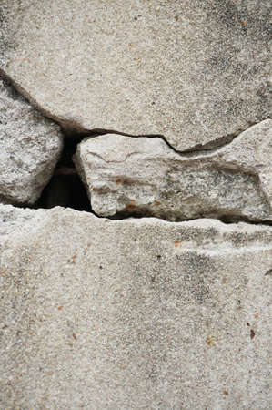 A photo of hole in the crack cement concrete wall surface texture, the conceptual background, closeupの写真素材