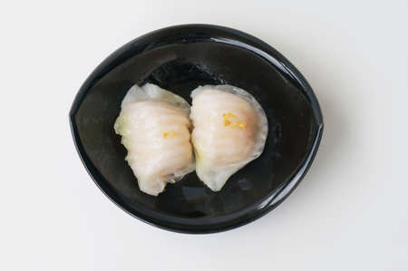 Asia - Asian eating food, Chinese food, Ha Gaw Dim Sum: Chinese Steamed Dumpling on black bowl isolated on white background, close upの写真素材