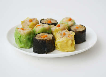Asia - Asian eating food, Chinese food, Shumai Dim Sum: Chinese Steamed Dumpling, a steamed dumpling with the dough gathered at the top, on white plate isolated on white background, close upの写真素材