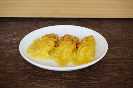 Asia - Asian eating food, Chinese food, Wonton Dim Sum: Chinese Steamed Dumpling, a steamed Wonton on white plate on wooden background, close upの写真素材