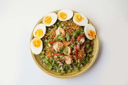 Asia-Asian eating food, Thai foof, Yum Tua Poo: Spicy Shrimp and betel nuts salad or Winged bean salsa, with boil eggs isolated on white background, close upの写真素材