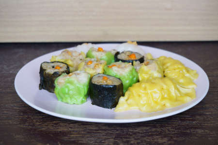 Asia - Asian eating food, Chinese food, Dim Sum: Chinese Steamed Dumpling and Shumai on plate on wooden background, close upの写真素材