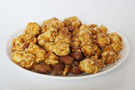 Caramel popcorn on white plate isolated on white backgroundの写真素材