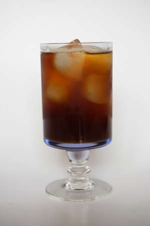 Cola, black coffee, on champagne glass on white plate isolated on white backgroundの写真素材