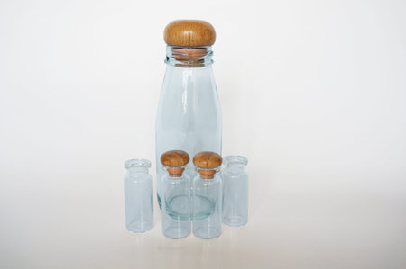 Empty colorless glass bottles isolated on white backgroundの写真素材