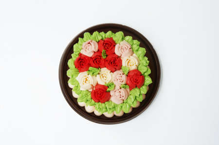 A photo of colorful cream Vanilla Rosses cake isolated on white background, close upの写真素材