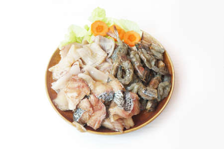 Raw foods: Fresh squid, white leg shrimp or pacific white shrimp (Litopenaeus vannamei, formerly Penaeus vannamei) and fish with chinese cabbage isolated on white background, close upの写真素材