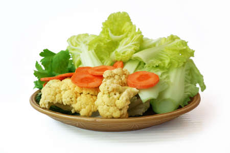 Vegatables set - diet food for health: green sweet basil (Thai basil), Celery (Smallage), morning glory, cauliflower, Chinese cabbages and orange carrots on plate isolated on white backgroundの写真素材