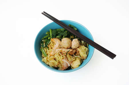 Asia - Asian eating food, Chinese food: a bowl of dried pork and wonton with noodles and meat ball isolated on white background, close upの写真素材