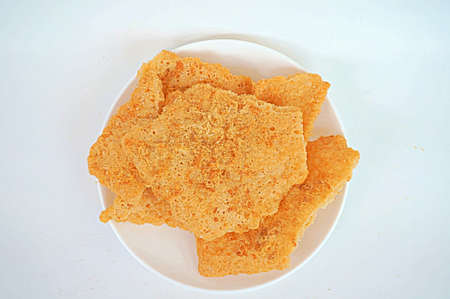 Asia-Asian, Thai food: a photo of Dried shredded flossy pork Rice cracker on white plate isolated on white background, close upの写真素材