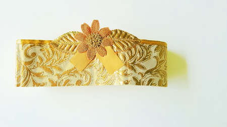 A photo of decorative golden silk bows with horizontal gold ribbons, for decoration, promotion, advetrisment, sale or celebration on chirstmas, new year, valentine, birthday, wedding anniversary, isolated on white background, close upの写真素材