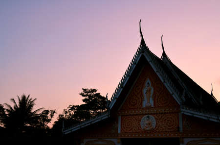 Roof temple in sunset at Thailandの写真素材