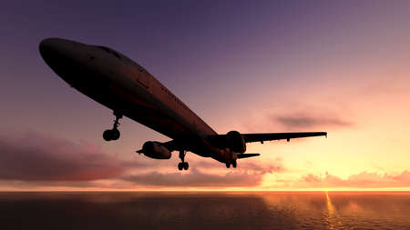 The plane was flying over the ocean on sunsetのeditorial素材