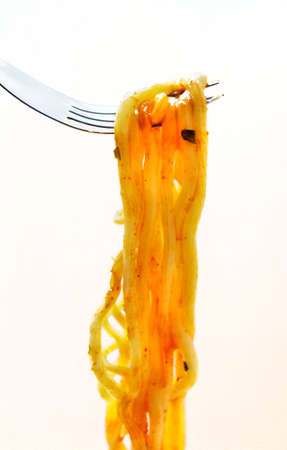 Instant noodles on a spoon with white background.の写真素材