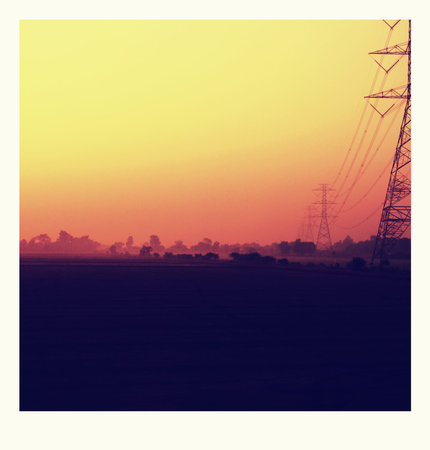 electricity post on  rice fields in the sunsetの写真素材