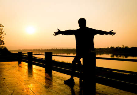freedom life of people with river at sunset.の写真素材
