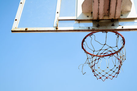 Basketball hoop in outdoor basketball field with blue sky