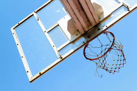 Basketball hoop in outdoor basketball field with blue skyの写真素材