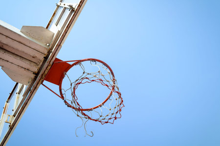 Basketball hoop in outdoor basketball field with blue skyの写真素材