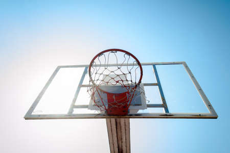 Basketball hoop in outdoor basketball field with blue skyの写真素材
