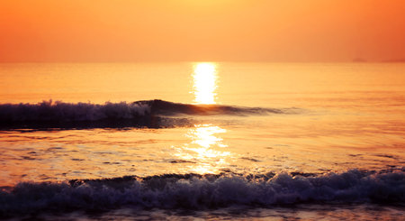 Sunset on the beach with wave of sea