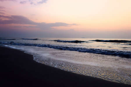 Sunrise on the beach with wave of seaの写真素材