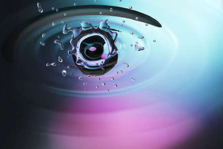 blue water drop on water clean with colorful backgroundの写真素材